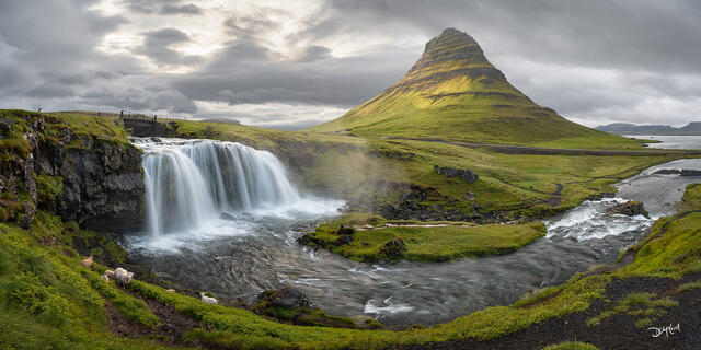 Kirkjufell mountain and Kirkjufellfoss waterfall in Iceland summer afternoon fleeting light.