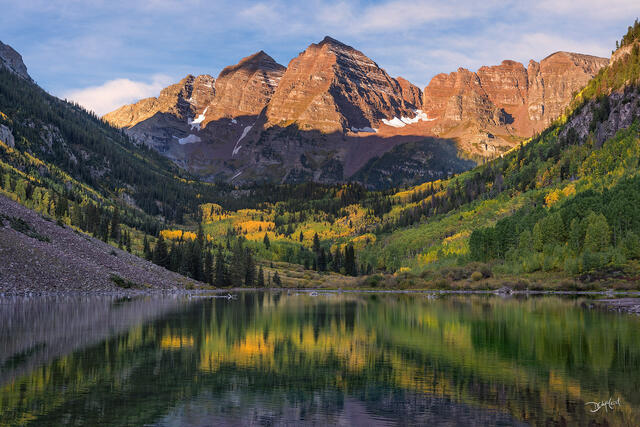 Maroon Bells reflected in lake at sunrise in Colorado, USA.