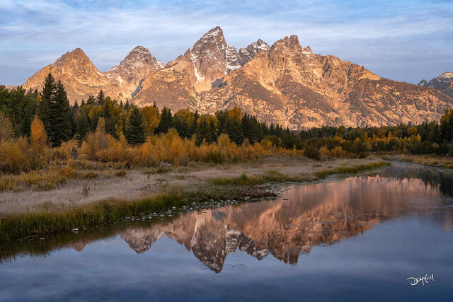 Teton Range reflected in Schwabacher Bay at sunrise in Wyoming.
