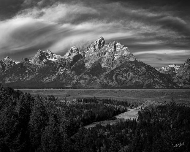 Grand Teton mountain range with Snake River under storm clouds (black and white).