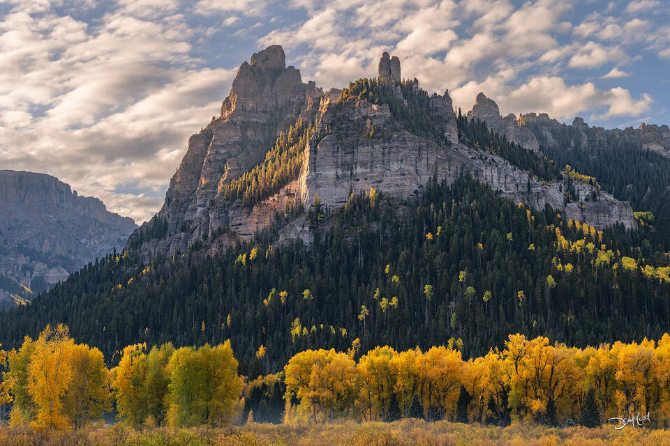Pinnacle Ridge at sunrise with autumn trees in Colorado, USA.