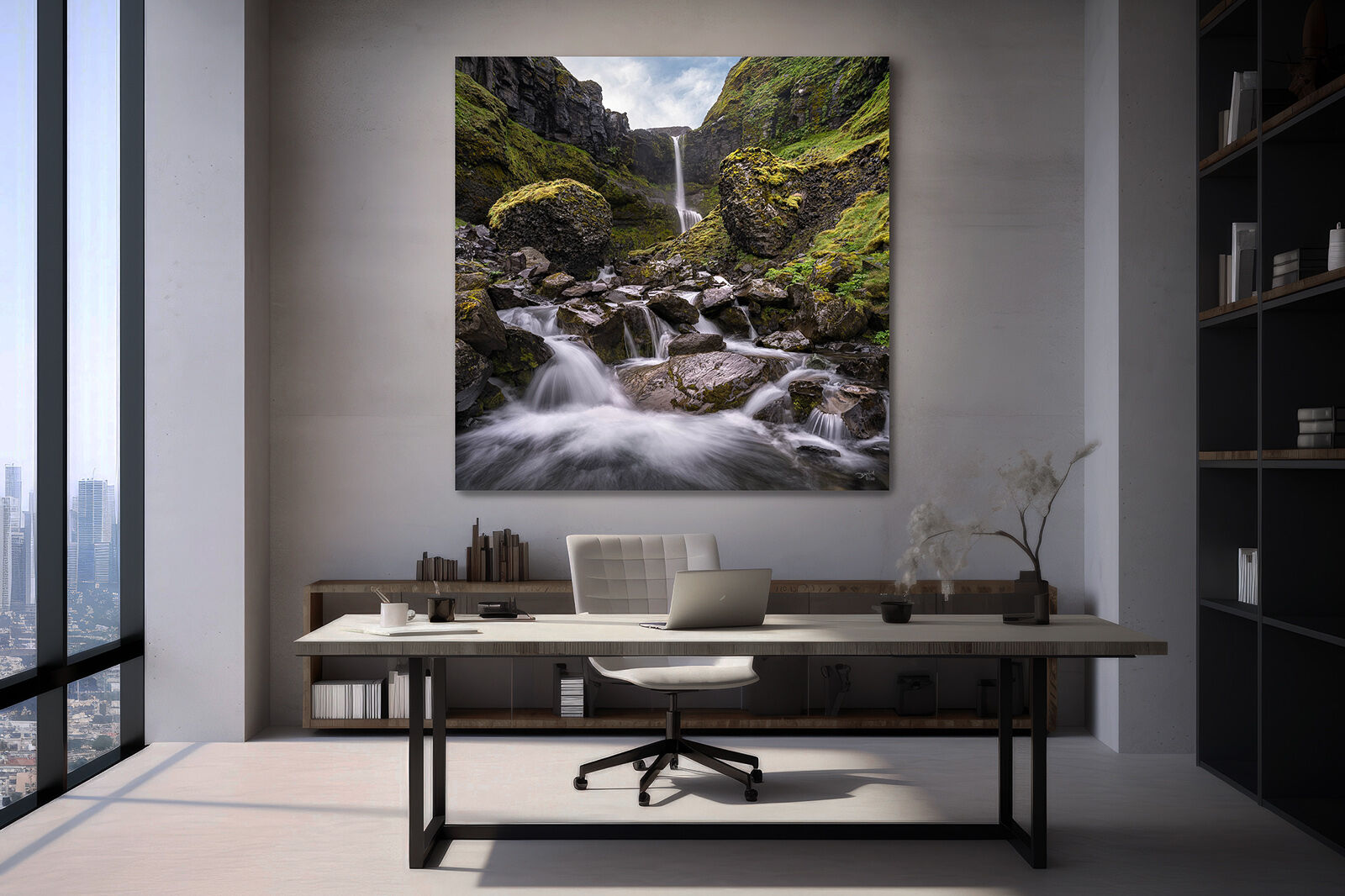A large photographic print of Bugsfoss waterfall in Iceland hangs in an office setting