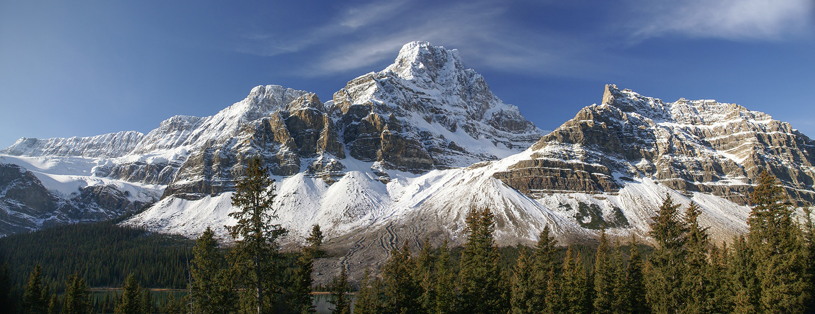 Crowfoot Glacier and Crowfoot Mountain viewed from the Icefields Parkway with layered rock, ice, and alpine textures, Banff National Park.