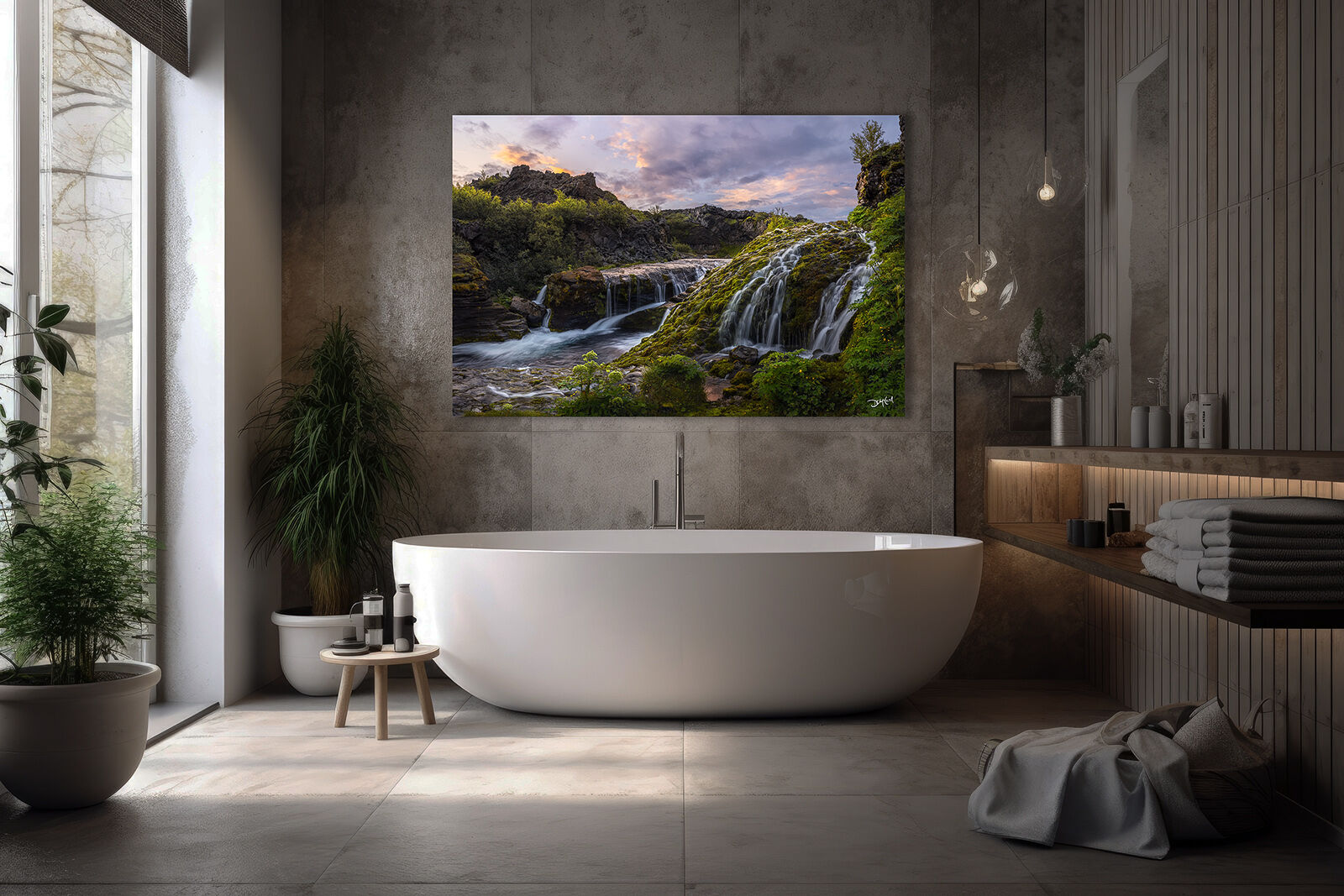 A photographic print of Gjain waterfall valley in Iceland hangs over a bathtub to create a soothing atmosphere.