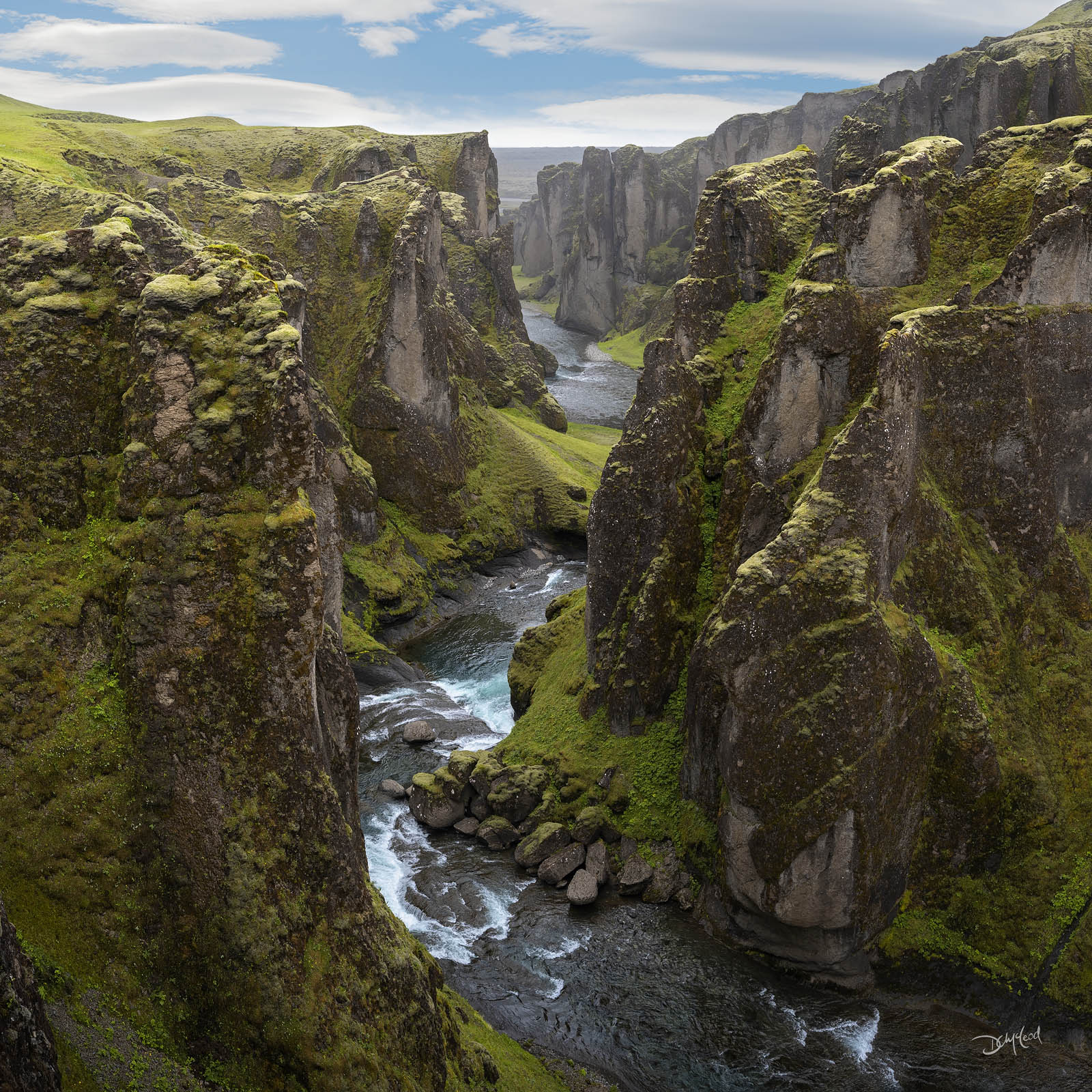 Fjaðrárgljúfur Canyon Fjaðrárgljúfur Canyon in Iceland under a sunny sky.
