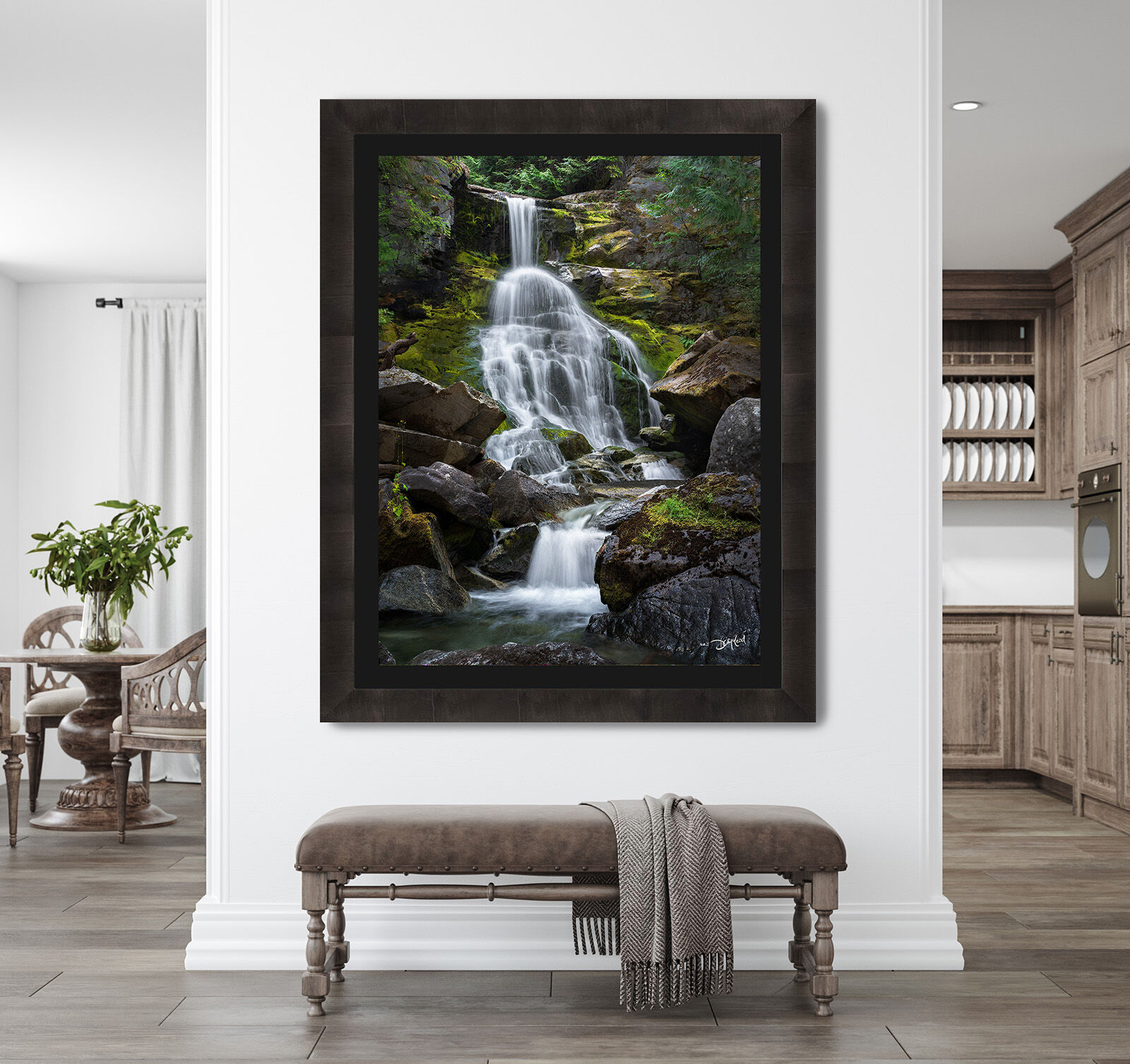 A large photographic print of Glade Creek Falls in British Columbia hangs on a wall above a bench in an upscale home.