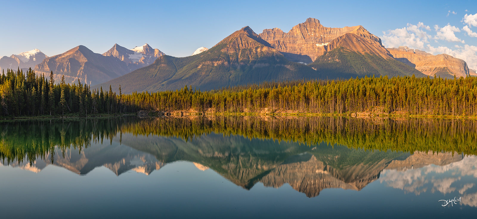 Sunrise reflections at Herbert Lake along the Icefields Parkway with Mount Temple and Mount Niblock mirrored in calm water, Banff National Park, Alberta.