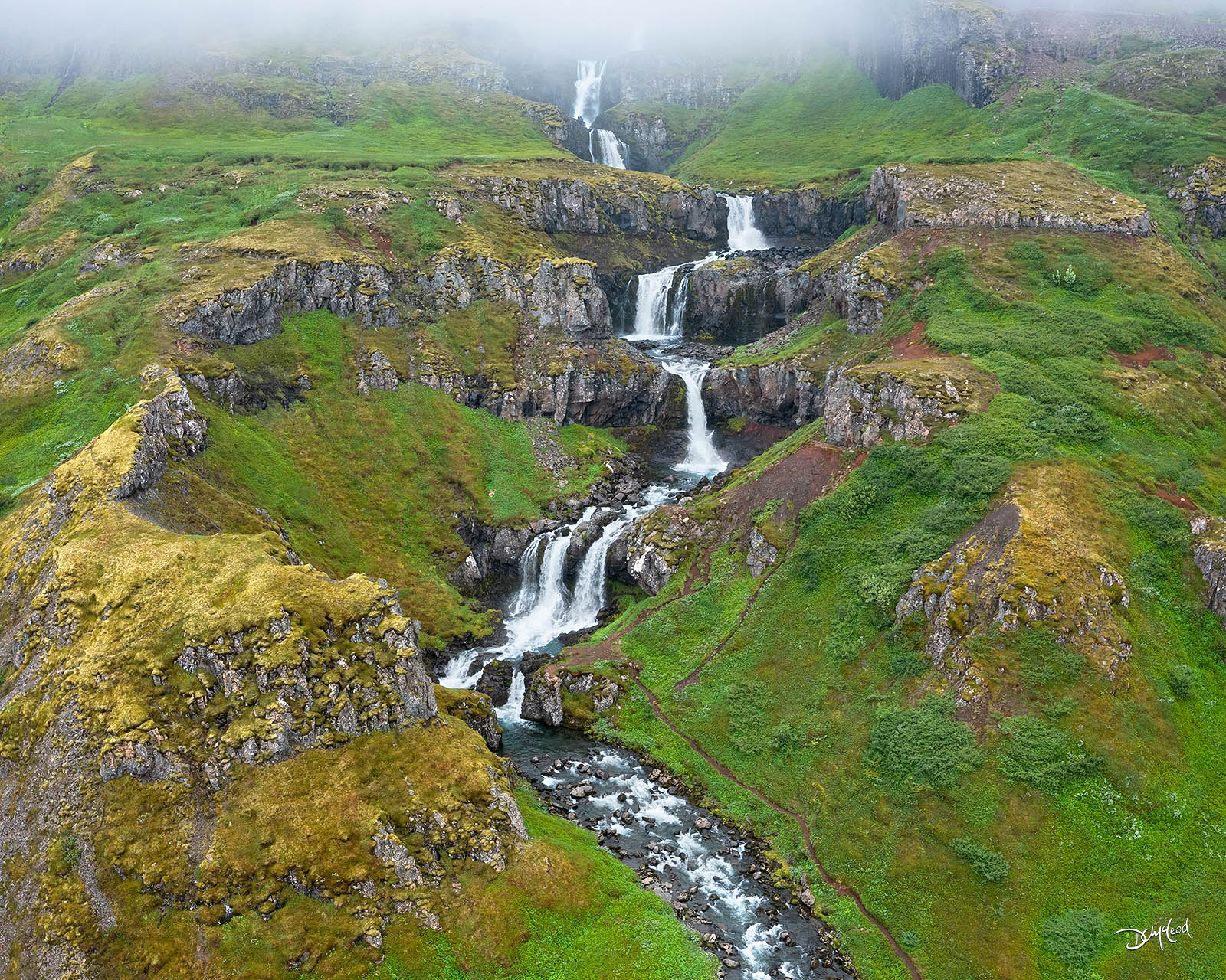 Klifbrekkufoss waterfall in Iceland as seen from an aerial view.