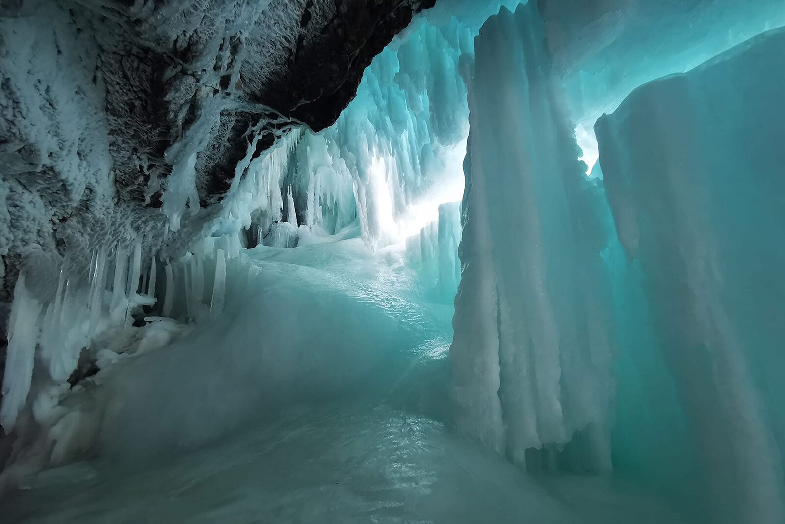 The frozen blue ice of Panther Falls in winter on the Icefields Parkway.