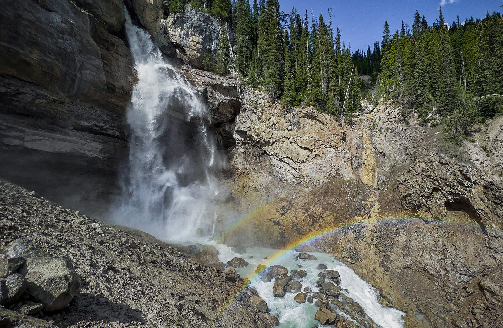 Panther Falls cascading over layered rock formations beside the Icefields Parkway, Banff National Park.