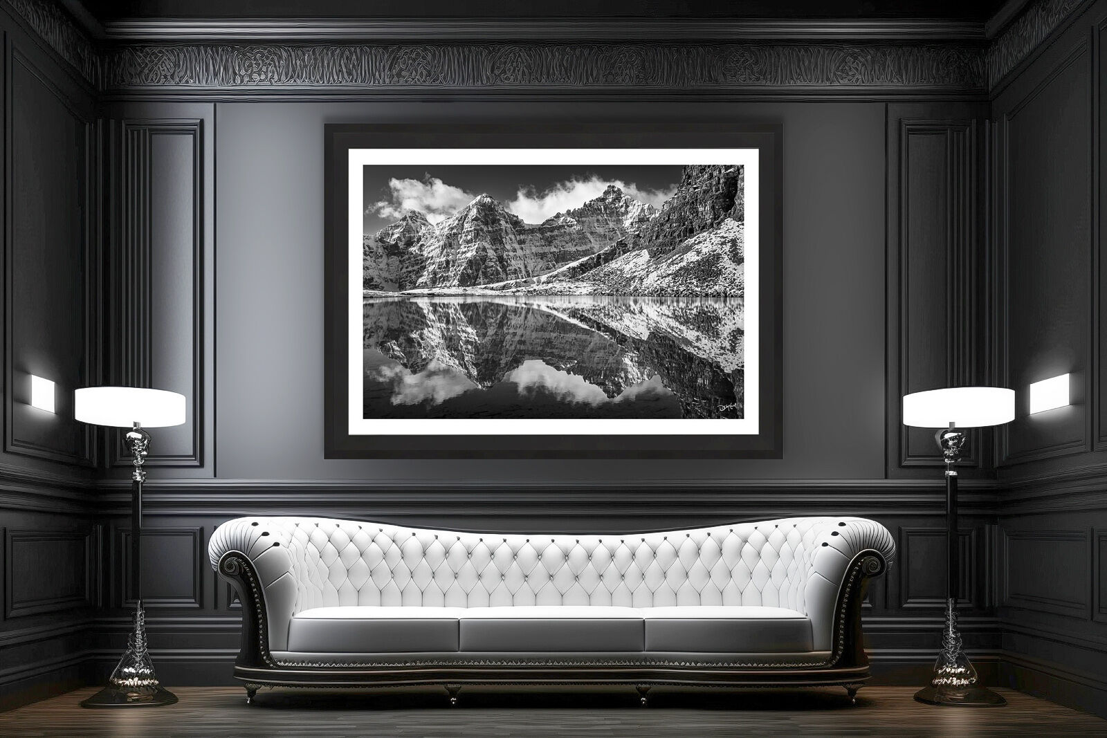 Black and white mountain photo of the Valley of the Ten Peaks displayed above a white leather sofa in a modern living room.