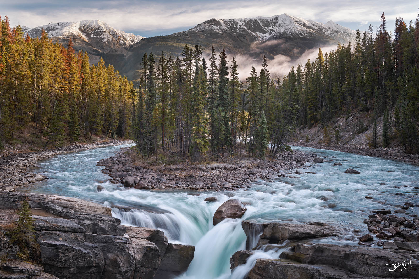 Sunwapta Falls horizontal composition surrounded by forest and mountains.
