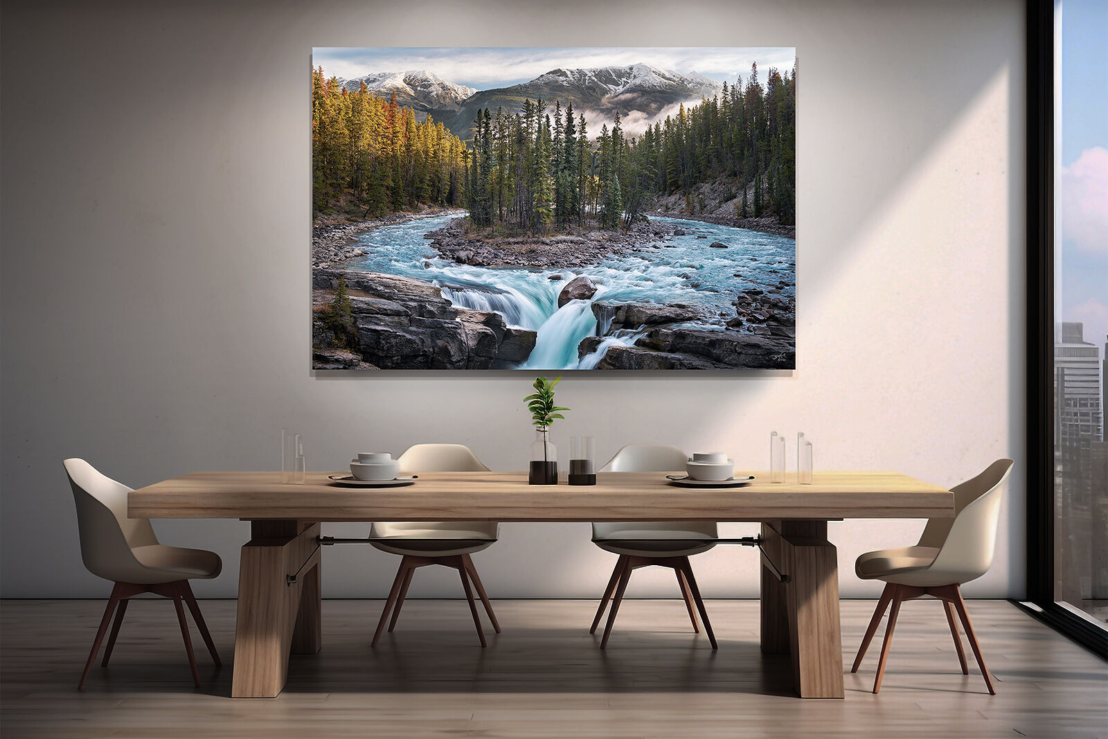 A large photographic print of Sunwapta Falls hangs on the wall in a large dining room with a table and chairs.