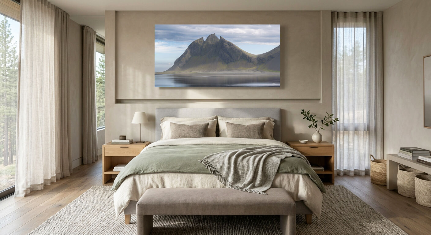 Peaceful bedroom featuring a panoramic fine art landscape photograph displayed above the bed to create a calm, relaxing atmosphere.
