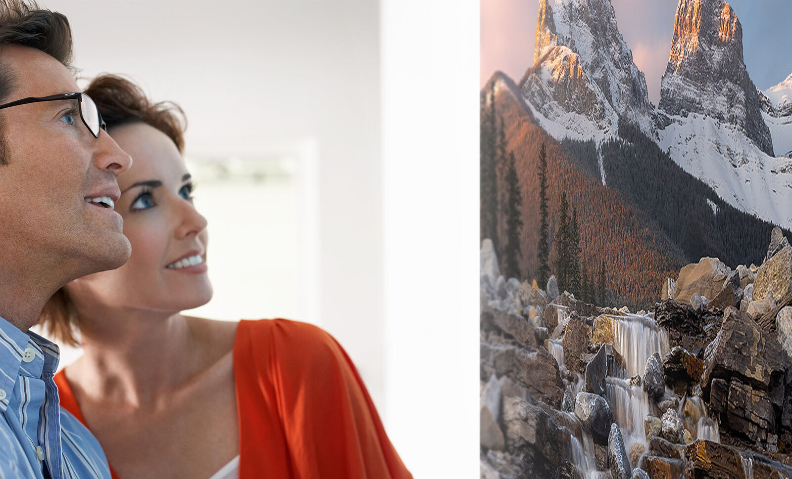 Couple admiring triptych wall art in their home