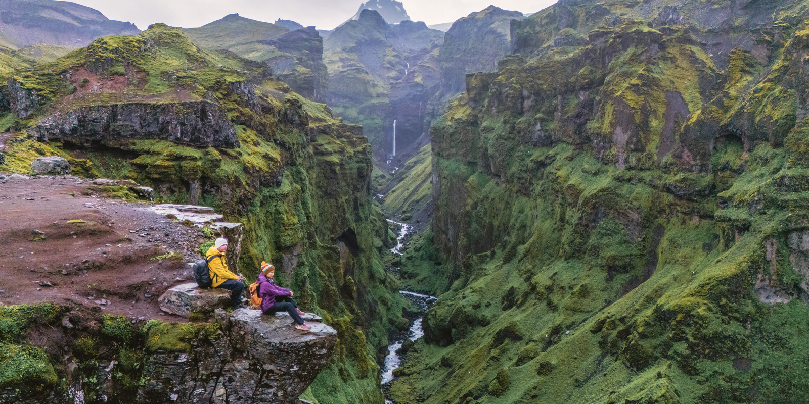 Hikers overlooking M&uacute;laglj&uacute;fur Canyon in Iceland.