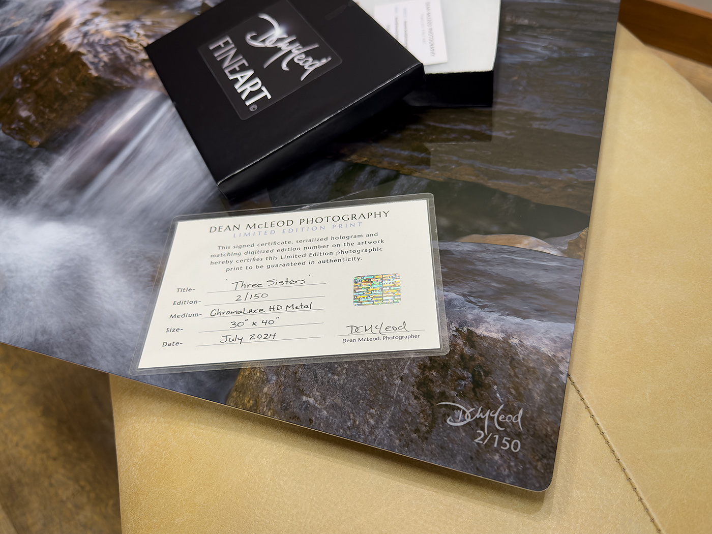 Corner detail of a limited-edition fine art print showing the artist's signature, edition number, and accompanying Certificate of Authenticity.
