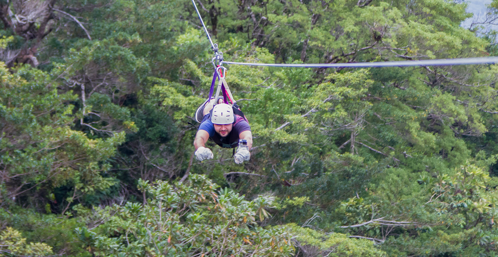 Man on a zipline in the forest canopy of Costa Rica.